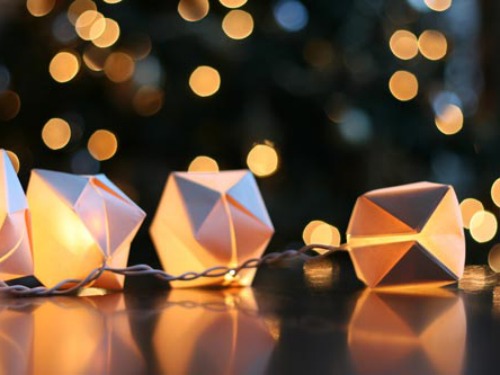 All you need is some plain white paper and nimble fingers to create this festive display. For safety, chose a string of LED bulbs, which don't heat up.
Get the tutorial from Wit & Whistle »