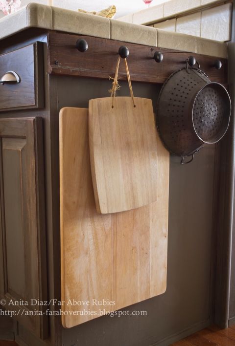 Heavy, clunky kitchen tools, like cutting boards and colanders, fit awkwardly into cabinets — so why not hang 'em on the outside instead? This way they'll be easy to grab and put away.<br />See more at Far Above Rubies »<br />