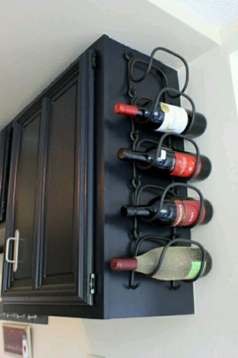Instead of taking up space with a bar cart, hang a wire holder from the side of a cabinet. Even better? Hang it from the cabinet that holds the wine glasses so all the essentials are within reach after a long day.<br />See more at Between 3 Sisters »<br />
