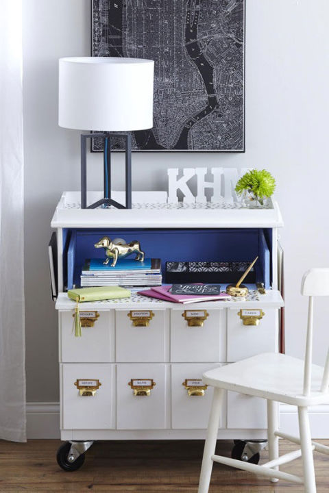 This transformation requires some serious handy work. By making it fold out, the top drawer becomes the main surface for a desk. This blogger was even crafty enough to add her initials. See more at In My Own Style » 