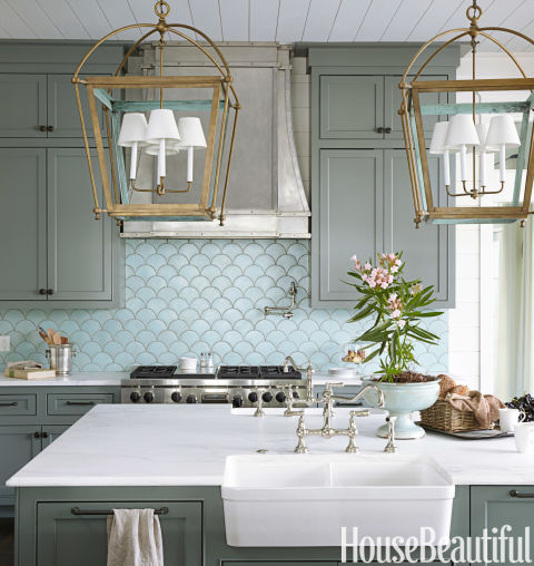 The ocean's shimmery hues inspire a kitchen in Santa Rosa Beach, Florida, by Urban Grace Interiors. The ocean's shimmery hues inspire a kitchen in Santa Rosa Beach, Florida, by Urban Grace Interiors. The blue-green wall tile sets the tone, reminding the designers of verdigris — the color you see on the inside of the brass lanterns. 
