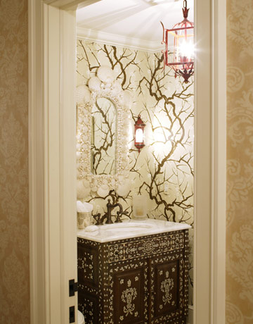 Enchanted forest meets princely bower, thanks to HB Home's pairing of woodland wallpaper with an inlaid cabinet they converted into a vanity.
