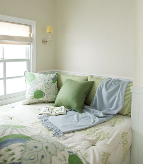 window seat with green linens