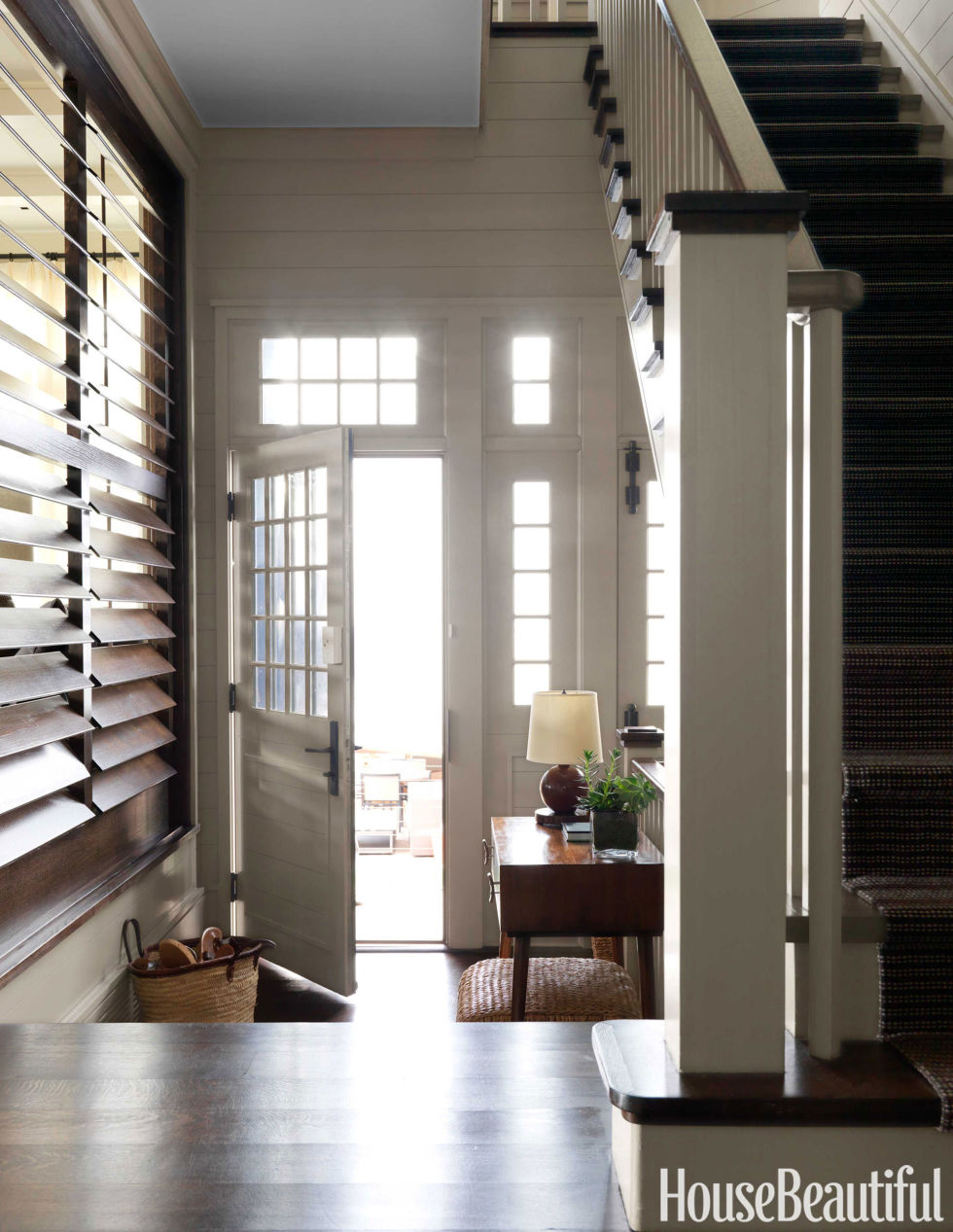 Luxurious entryway with rustic staircase and antique lights. front ...